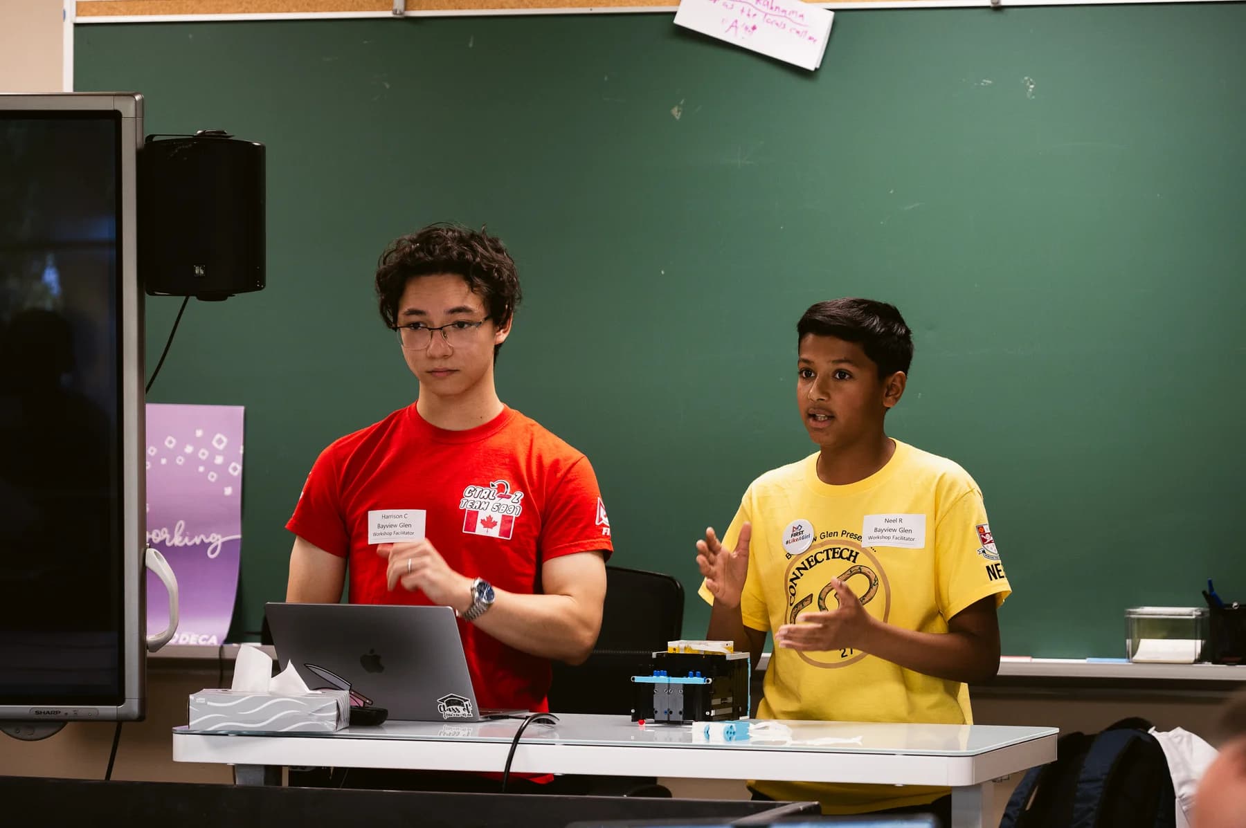 Workshop facilitators presenting with a LEGO robot